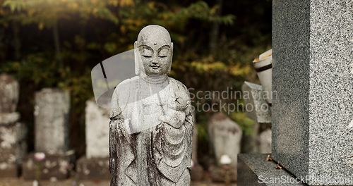 Image of Buddha, statue in Japan graveyard with child for safety, protection and sculpture outdoor in nature. Jizo, tombstone and memorial gravestone with history, culture and monument for sightseeing or trip