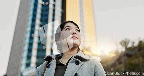 Image of Thinking, city and professional Japanese woman with music on morning commute, travel and walking in Tokyo. Earphones, corporate and person with ideas, ambition and future for career, business or job