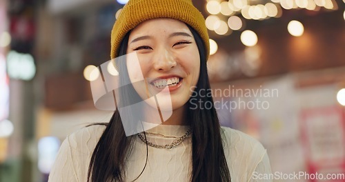 Image of Woman, Japanese and portrait in street at night for Tokyo travel destination, journey or happy. Female person, face and smile or road city light bokeh for holiday adventurer, vacation or downtown