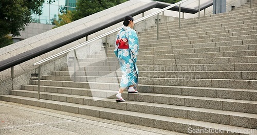 Image of Woman, Japanese and walking in kimono for traditional on stairs in Tokyo for wellness, health or peace. Female person, outdoor and urban city explore for downtown commute for local, steps or culture