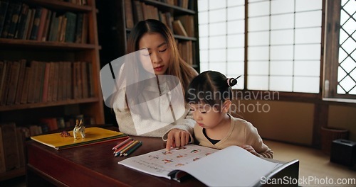 Image of Child, mother and teaching education in home for drawing in Japanese or tutor schooling, development or book. Female person, girl daughter and pencils in Tokyo or writing lesson, studying or creative