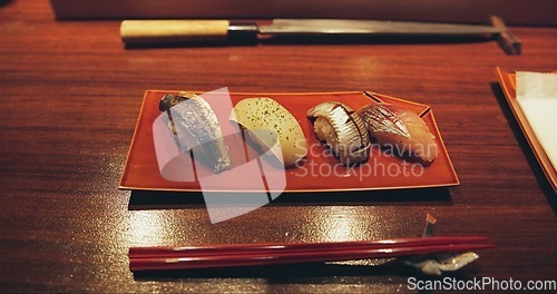 Image of Table, restaurant and Japanese sushi for fish, raw salmon and healthy food on plate for asian culture. Japan, cuisine and rice for vitamins or nutrition, display and catering with seafood lunch menu