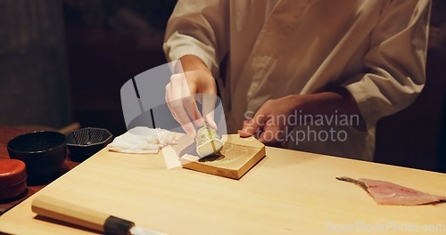 Image of Hands, cooking and wasabi with sushi chef in restaurant for traditional Japanese cuisine or dish closeup. Kitchen, salmon roll or seafood preparation and person working with gourmet meal ingredients