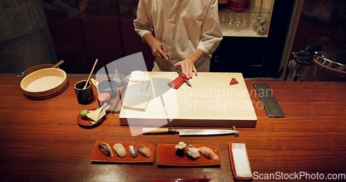 Image of Hands, cooking and sushi with chef in restaurant for traditional Japanese cuisine closeup from above. Kitchen, seafood dish preparation and person working with gourmet meal recipe ingredients