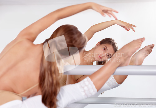 Image of Reflection, ballerina and stretching legs on barre in classroom, practice and student exercise. Ballet, flexibility and girl on mirror training, dance choreography for art or performance for fitness