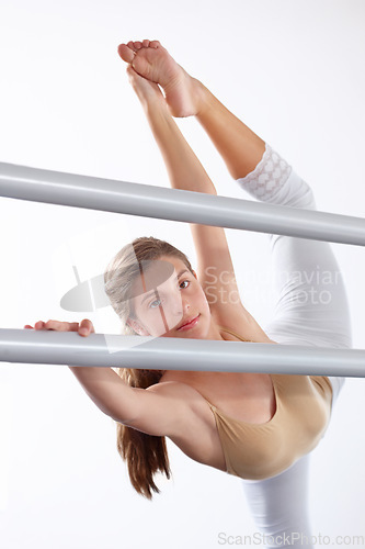 Image of Portrait, ballet and girl stretching legs on barre in classroom, practice and student exercise. Ballerina, flexibility and warm up for training, dance choreography for art or performance for fitness