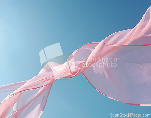 Image of Flying pink fabric wave on blue sky background and illuminated b