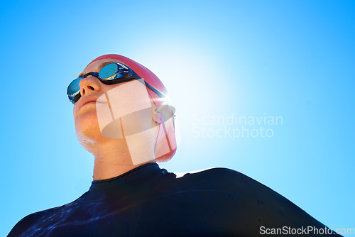Image of Swimmer, woman with low angle and athlete outdoor, blue sky with sunshine and water sport for fitness. Exercise, training for swimming and workout, summer and lens flare with mockup space and goggles