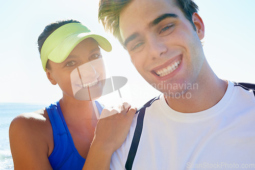 Image of Couple, outdoor and portrait in beach front, exercise and fitness with smile, training and sunrise for run. Man, woman and athletic for ocean, sea and ready together in summer, happy and workout