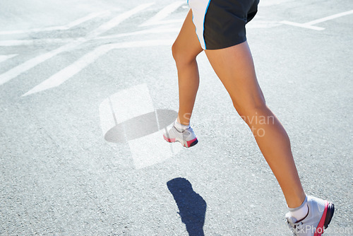Image of Closeup, running and legs with woman, training and exercise with commitment, endurance and challenge. Person, athlete and runner with sneakers, workout and fitness with wellness, healthy and cardio