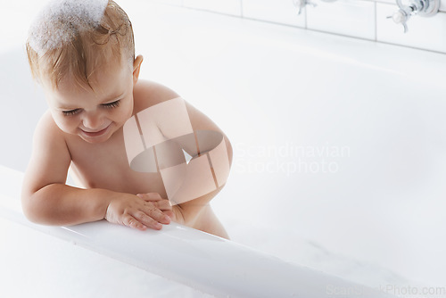 Image of Happy baby in bath with soap, bubbles and cleaning on mockup in morning routine for hygiene, wellness and care in home. Toddler washing in foam with smile, relax and laughing child in tub in bathroom