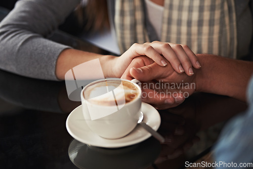 Image of Coffee cup, cafe and relax couple holding hands for support, comfort or love on morning date with caffeine beverage. Wellness, marriage partner or closeup of people bonding over restaurant drink