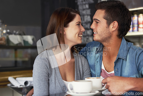 Image of Smile, shop and couple drinking coffee in cafe, care and bonding together on valentines day date. Happy, man and woman in restaurant with latte for love connection, conversation and relationship