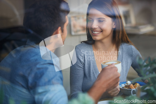 Image of Relax woman, happy and couple on coffee shop date, lunch break or enjoy diner conversation, chat or eye contact. Relationship partner, restaurant window and girlfriend talking with boyfriend in cafe