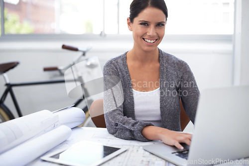 Image of Woman, architecture planning and laptop in office portrait for floor plan research, design software and startup project. Engineering worker or designer typing on computer with blueprint and documents