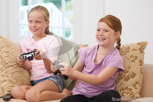 Image of Home, controller or happy kids gaming to play online with joystick on couch or sofa in living room. Children, fun experience or young girl gamers with smile for video games, contest or technology