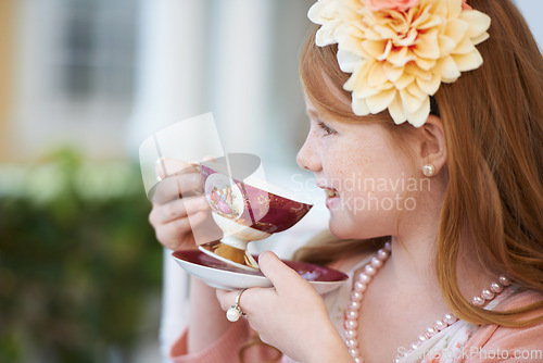 Image of Girl, child and happy with tea in garden with party for birthday, celebration and playing outdoor in home. Person, kid and porcelain cup in backyard of house with dress up, beverage and role play fun