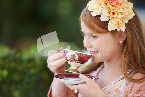 Image of Girl, child and smile with tea in garden with party for birthday, celebration and playing outdoor in home. Person, kid and porcelain cup in backyard of house with dress up, beverage and role play fun