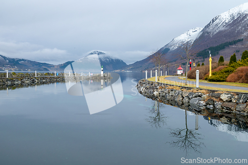 Image of Serene Winter Morning at a Snow-Dusted Lakeside With Reflective 