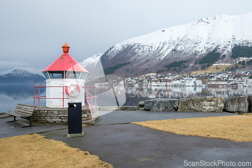 Image of Picturesque Lighthouse Overlooking a Calm Lake in a Small Mounta