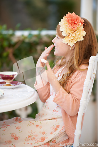 Image of Girl, child and tea party or dress up outdoor for fun fantasy game, play or make believe. Female person, flower crown and happy in nature backyard for fancy beverage drinking in garden, joy or summer