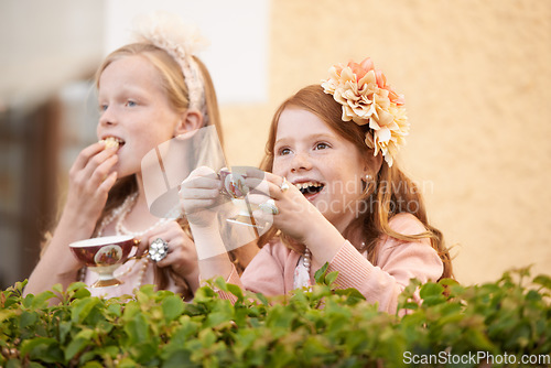 Image of Girl, friends and tea party in backyard for happy dress up game, fantasy or playing. Female people, siblings and hot drink in garden nature for summer bonding fun or kid lunch, birthday or beverage