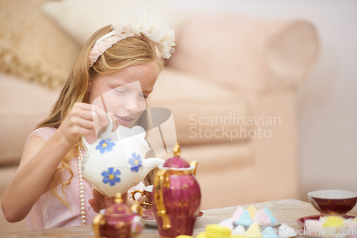 Image of Girl, tea pot and party in home for birthday celebration fun or sweet dessert for dress up fancy game, play or snack. Female person, child and candy food in living room for holiday, event or lunch