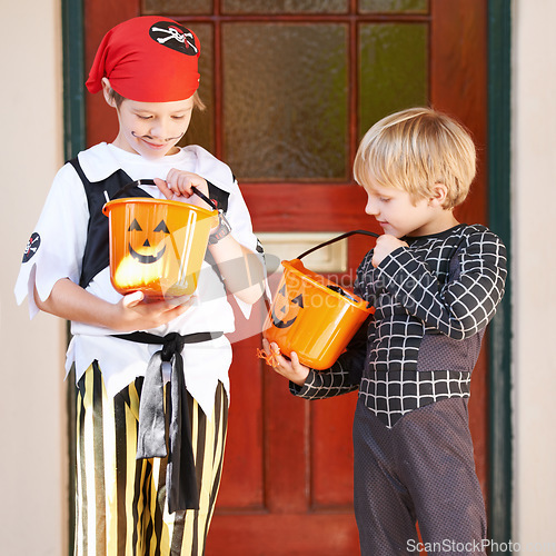 Image of Halloween, candy and door with children in costume on porch for trick or treat celebration together. Friends, food and sweets with young boy kids in fancy dress for spooky holiday or vacation