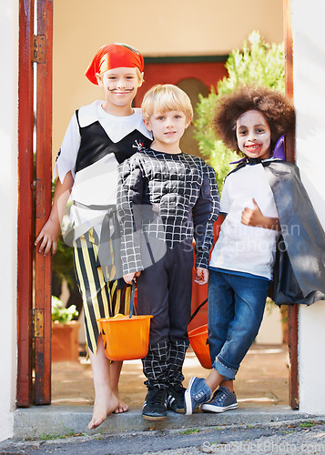 Image of Children, halloween and celebration in costume or portrait in front yard, holiday and spooky outfit or tradition. Kids, face and role play with basket, fancy dress and happiness in garden of home