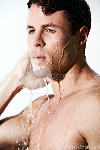 Image of Face of man in shower to relax, cleaning hair and body for morning wellness, hygiene and skin routine. Grooming, skincare and male model with muscle washing with water, self care and calm bathroom.