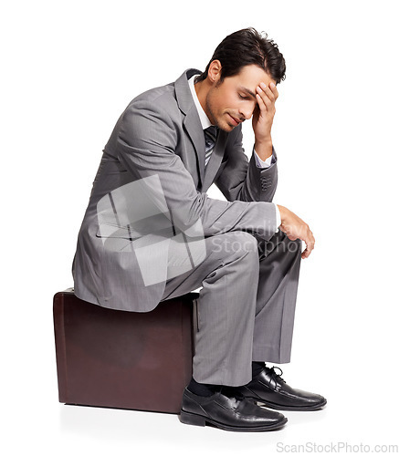 Image of Thinking, stress and business man with briefcase in studio for travel, fail or mistake on white background. Doubt, anxiety and person sitting on a bag with headache, disaster or compliance problem