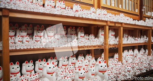 Image of Japan, traditional and neko maneki or group in shop for good luck cat, fortune or culture. Sculpture figure, gotokuji and store for travel destination in Tokyo for local history, spiritual or gift