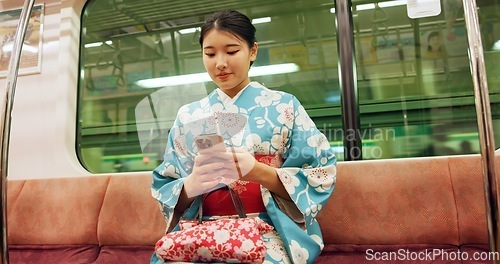 Image of Woman, japan and train with kimono, phone and travel with public transport, metro bullet in city. Person, journey or traditional clothes in motion blur on weekend or commute in tokyo on adventure