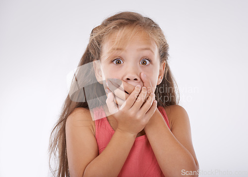 Image of Shock, portrait and hands over mouth, girl kid with reaction and unexpected news with surprise on white background. Announcement, alarm and youth in studio with facial expression and wow for drama