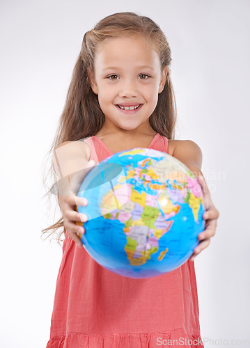 Image of Kid, portrait and globe in studio with world, planets and city for education, geography and happy. Student, girl child and travel map with smile for earth day support or lesson on white background