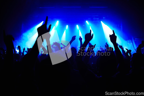 Image of Nightclub, party and audience with hands or lights for music, concert or rave festival with spotlight and dancing. Disco, psychedelic event and performance with entertainment, crowd and mock up space