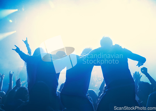 Image of Nightclub, people and audience with silhouette or lights for party, concert or rave festival with dance and dj. Disco, psychedelic event and performance with entertainment, crowd and hand gesture