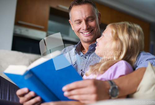 Image of Father, child and reading a book for learning at home, story and fantasy fiction for education. Daddy, daughter and bonding together on sofa, literacy and storytelling for language development