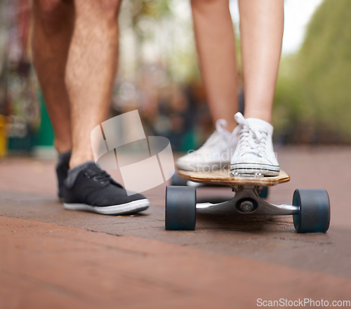 Image of Skateboard, learning and legs of couple of friends teaching partner skills, riding lesson or practice moving. Skate shoes, sneakers and closeup person coaching, help or support balance on ground