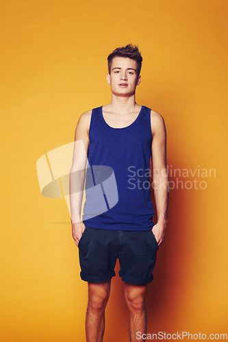 Image of Fashion, portrait and man in studio with trendy, cool or summer clothes on orange background. Style, attitude or serious male model with confidence, personality or casual, streetwear or outfit choice