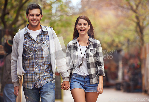 Image of Portrait, walk and couple holding hands, smile and happy on relax journey, morning trip or weekend date. Relationship bond, lover and young romantic people commute on street, road or sidewalk