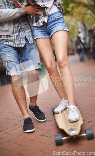 Image of Skateboard ride, legs and learning couple of friends teaching partner sports skills, exercise lesson or practice movement. Skate shoes, date and outdoor people helping, coaching and support balance