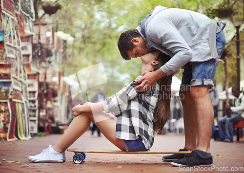 Image of Couple, sitting on skateboard and kiss in city, happy and romantic partner, learn together and relationship. Cape town, fun and hobby with boyfriend and girlfriend in street, love and dating