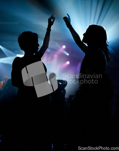 Image of People, dancing and crowd or concert silhouette for live music performance or festival, rock or friends. Audience, dj and stage lights for celebration rave or band sound as partying, weekend or night