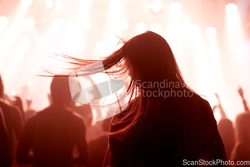 Image of Person, dancing and crowd or concert silhouette for live music performance or festival, rock or friends. Audience, club and red lights for celebration rave or band sound as partying, weekend or night
