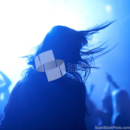 Image of Person, dancing and crowd or live concert silhouette or music performance or festival, rock or friends. Audience, club and blue lights or celebration rave or band sound as partying, weekend or night