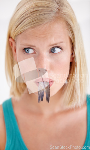 Image of Face, woman and confused with eating fish, tail and surprise on white background of studio. Crazy, diet and person with doubt in weird seafood, cuisine and taste gross or strange food in mouth