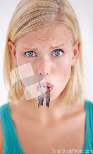 Image of Confused, woman and portrait eating fish, tail and surprise on white background of studio. Crazy, diet and person with doubt in weird seafood, cuisine and taste gross or strange food in mouth