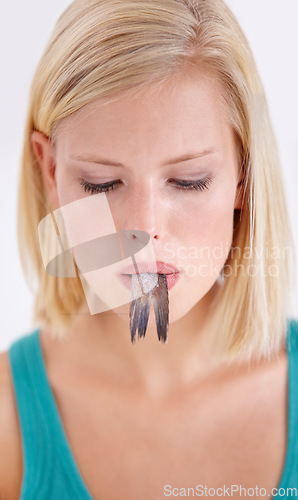 Image of Woman, face and eating tail of fish with surprise on white background, studio or mockup. Crazy, diet and person with doubt in weird seafood, cuisine and taste gross tuna or strange food in mouth