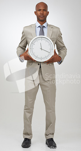 Image of Businessman, portrait and clock for deadline as professional lawyer for schedule, hurry or punctual. Black person, face and time or white background in studio or company job efficient, hour or mockup